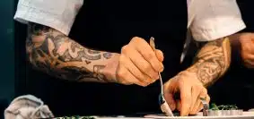 person putting food on plate