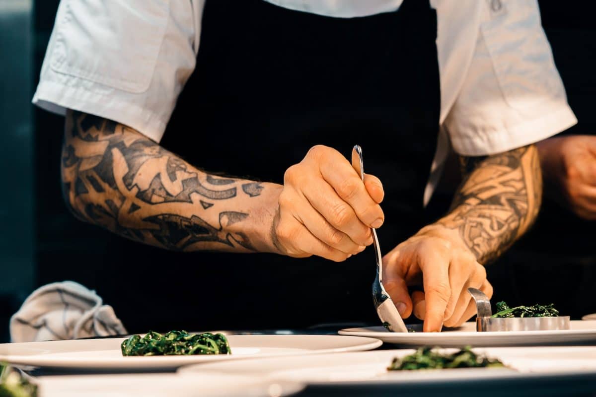 person putting food on plate